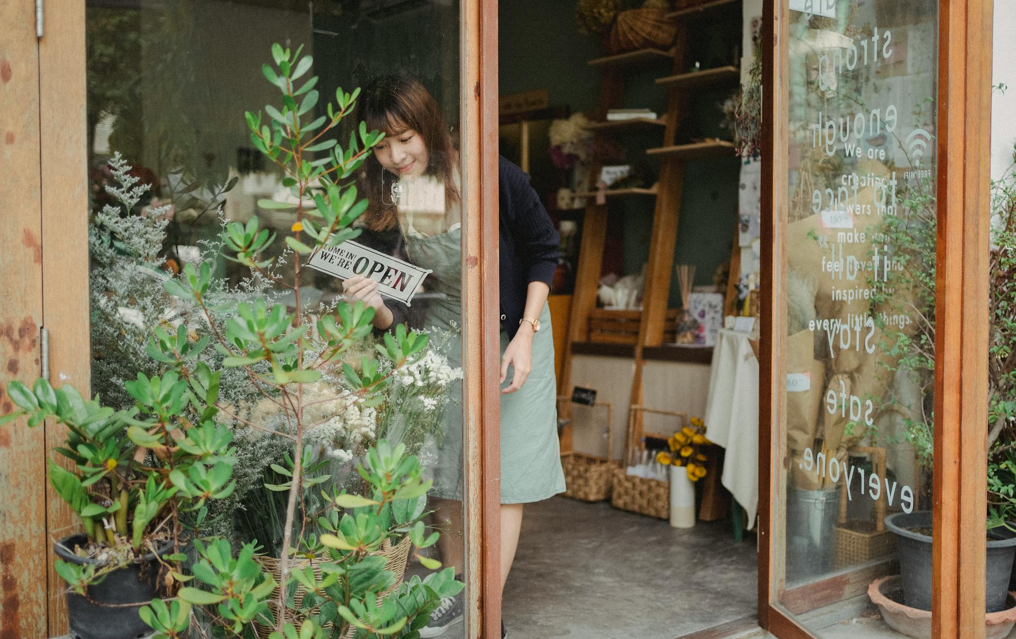 A small-business owner standing at the entrance of a local shop.